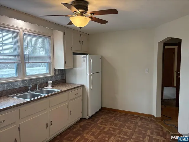 a kitchen with a refrigerator and a sink