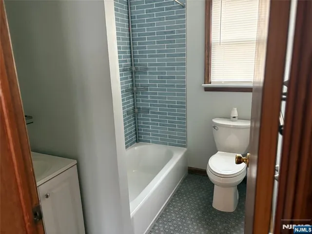 a bathroom with a toilet and a bathtub