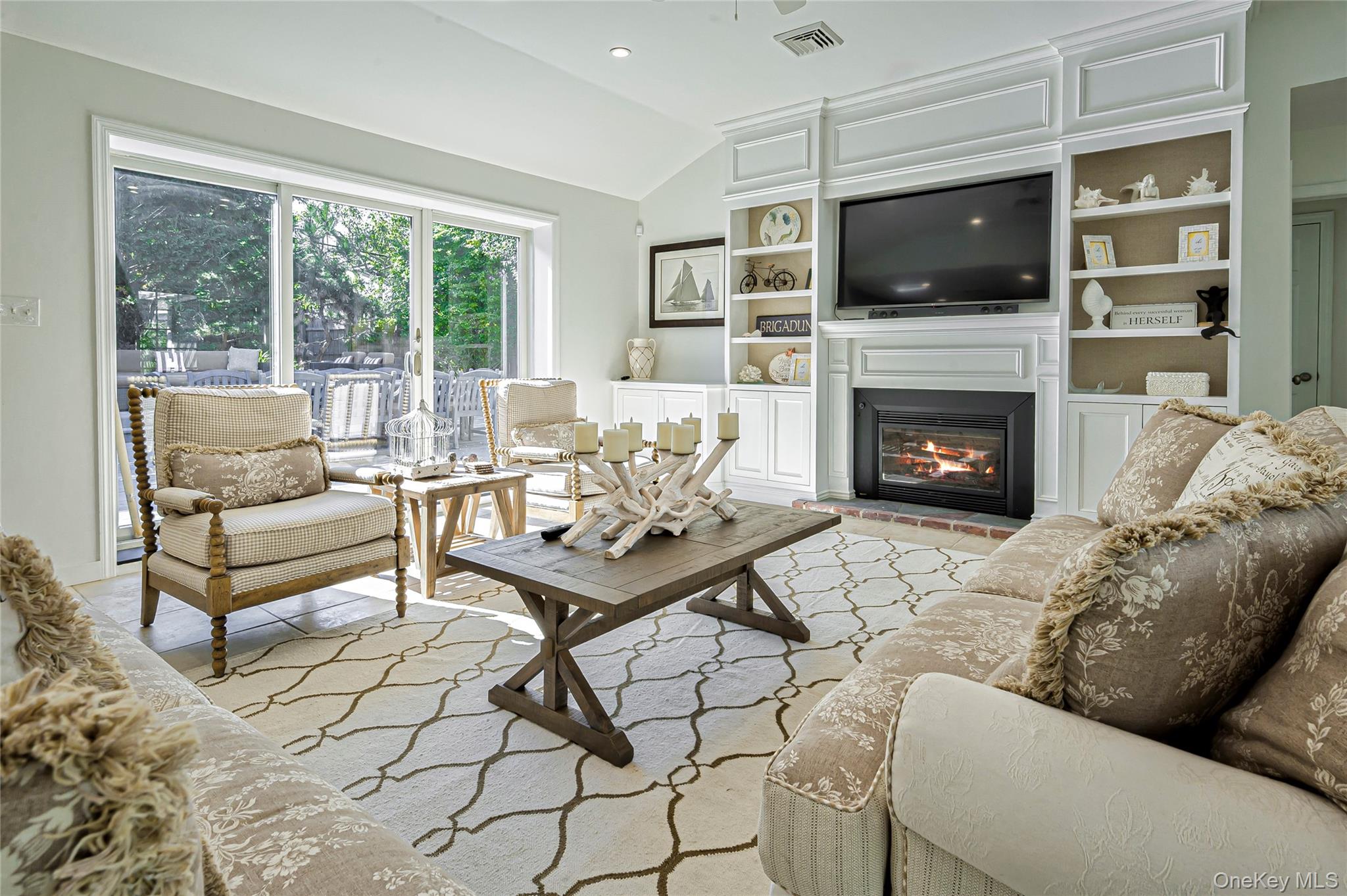 39 Sloop Walk Ocean Beach, NY 11770 - Photo 1 of 50 a living room with furniture a flat screen tv and a fireplace