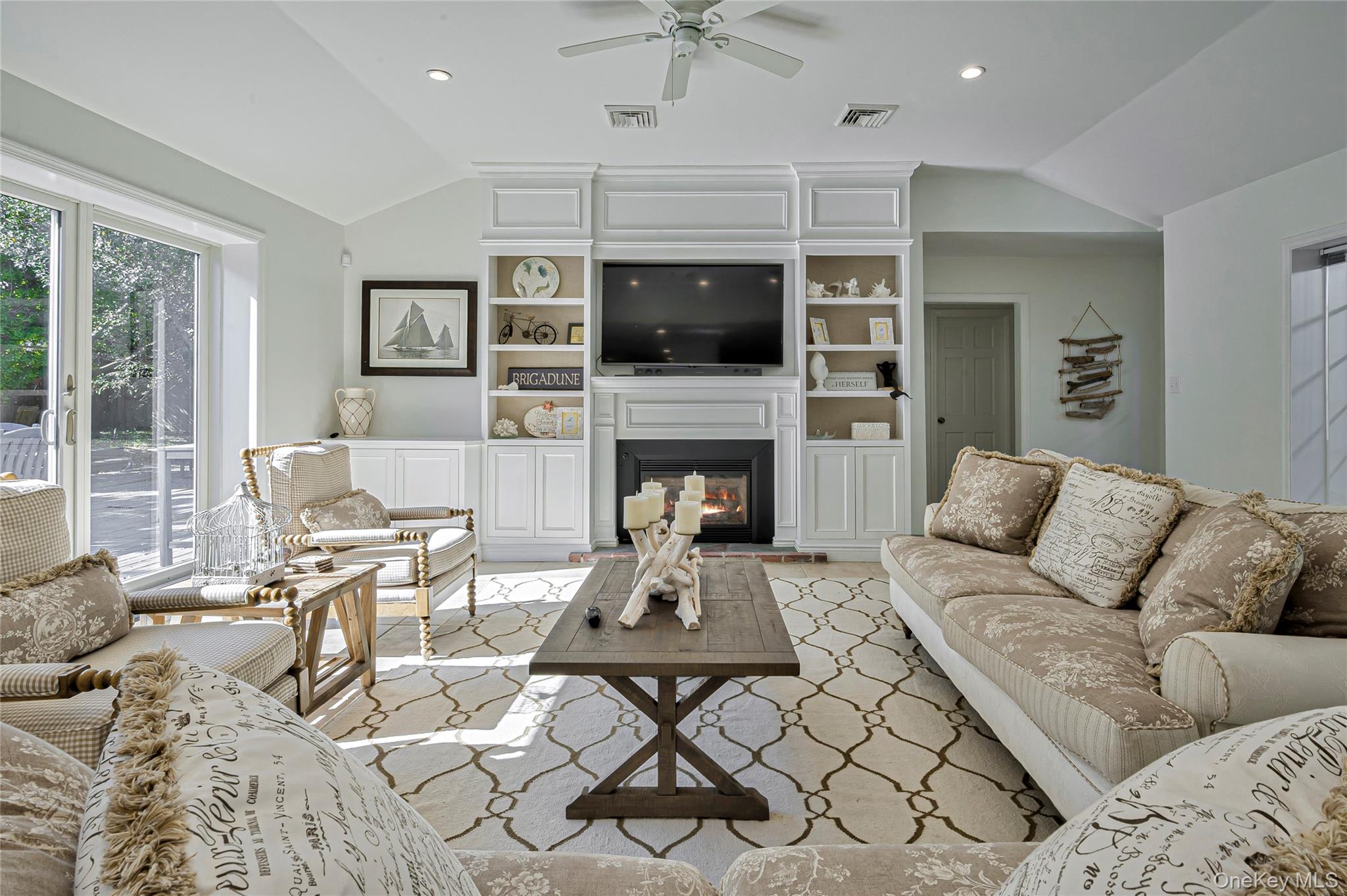 39 Sloop Walk Ocean Beach, NY 11770 - Photo 18 of 50 a living room with furniture a flat screen tv and a fireplace