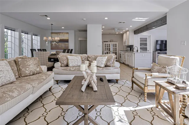 a living room with furniture kitchen view and a table