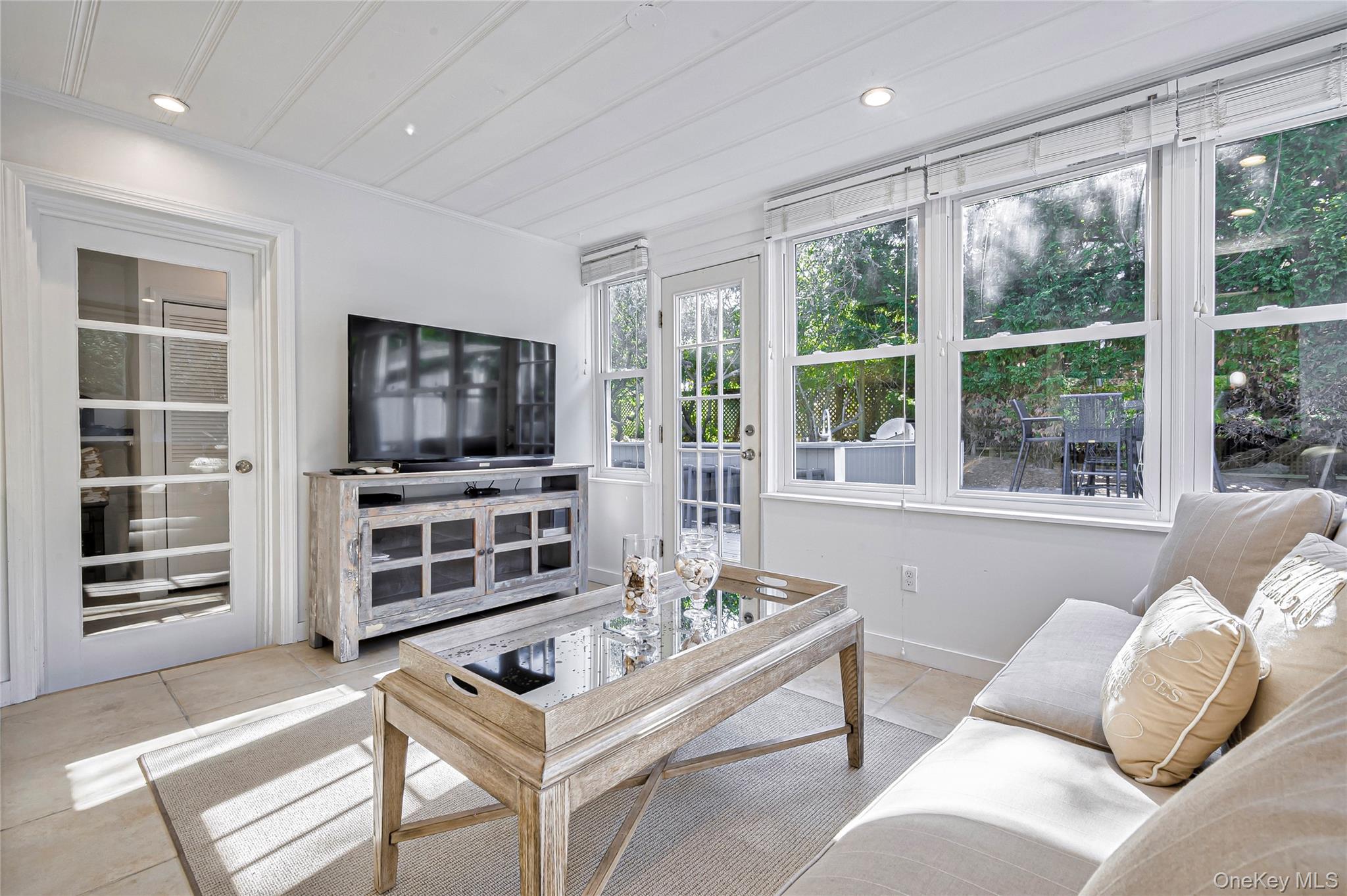 39 Sloop Walk Ocean Beach, NY 11770 - Photo 23 of 50 a living room with furniture a flat screen tv and floor to ceiling window
