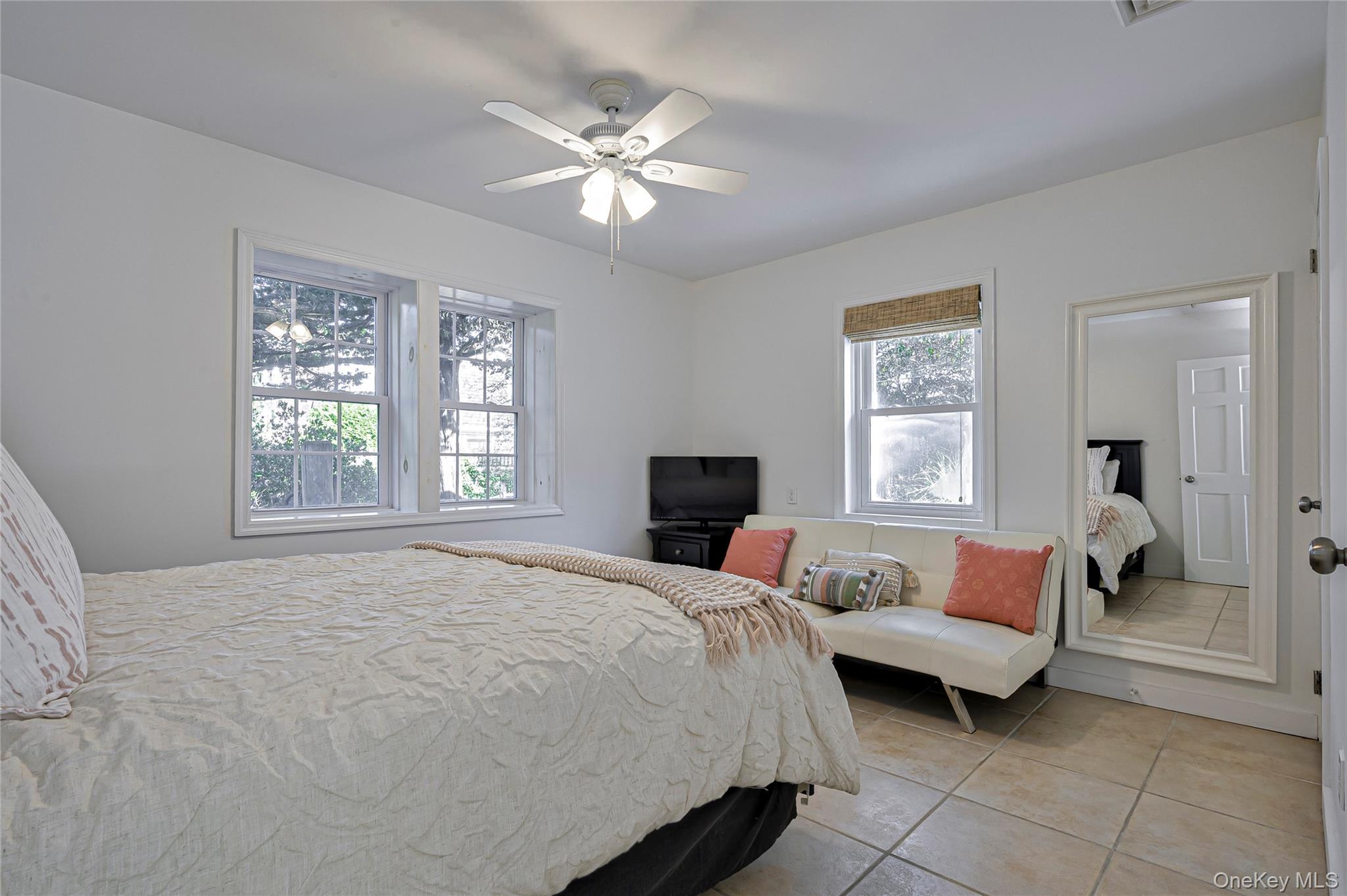39 Sloop Walk Ocean Beach, NY 11770 - Photo 26 of 50 a bedroom with a bed and a chandelier