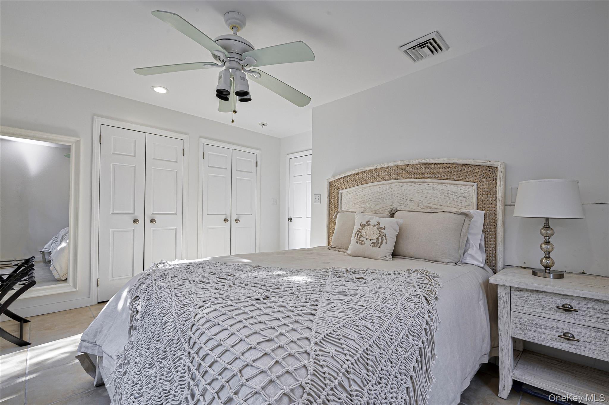 39 Sloop Walk Ocean Beach, NY 11770 - Photo 29 of 50 a bedroom with a bed and a chandelier