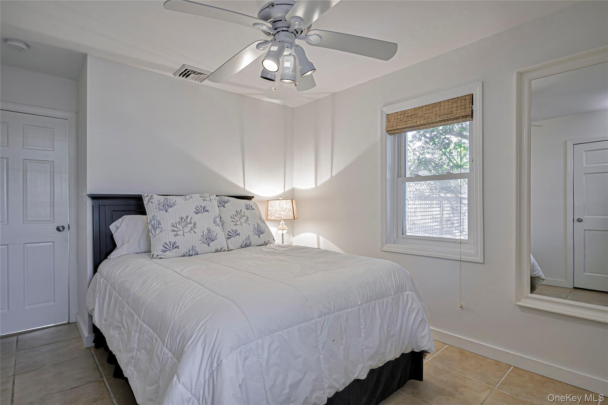 39 Sloop Walk Ocean Beach, NY 11770 - Photo 34 of 50 a bedroom with a bed and a chandelier