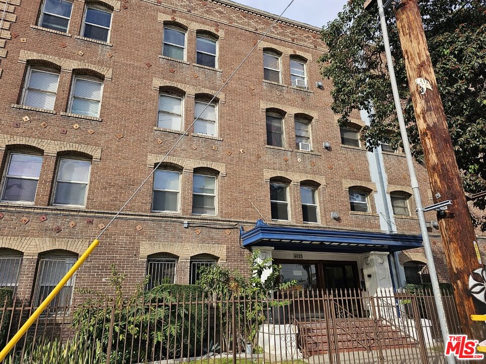 a view of a brick building with many windows