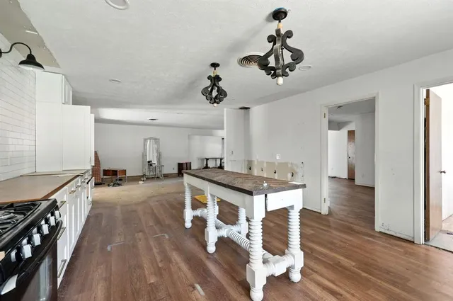a kitchen with stainless steel appliances granite countertop a stove and a refrigerator