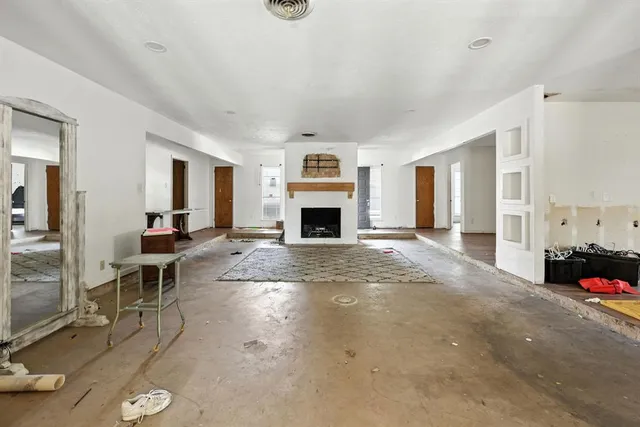 a view of a livingroom with furniture a fireplace and window