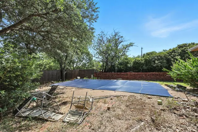 a view of yard with wooden fence