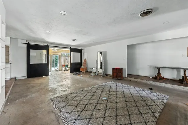a view of a livingroom with wooden floor and kitchen space