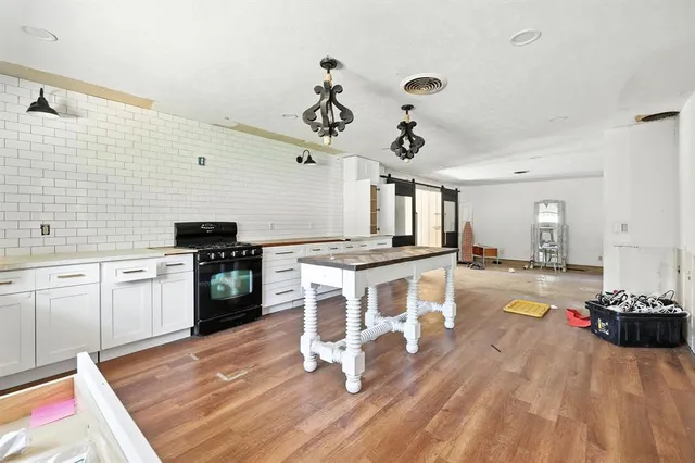 a living room with kitchen island granite countertop furniture and a kitchen view
