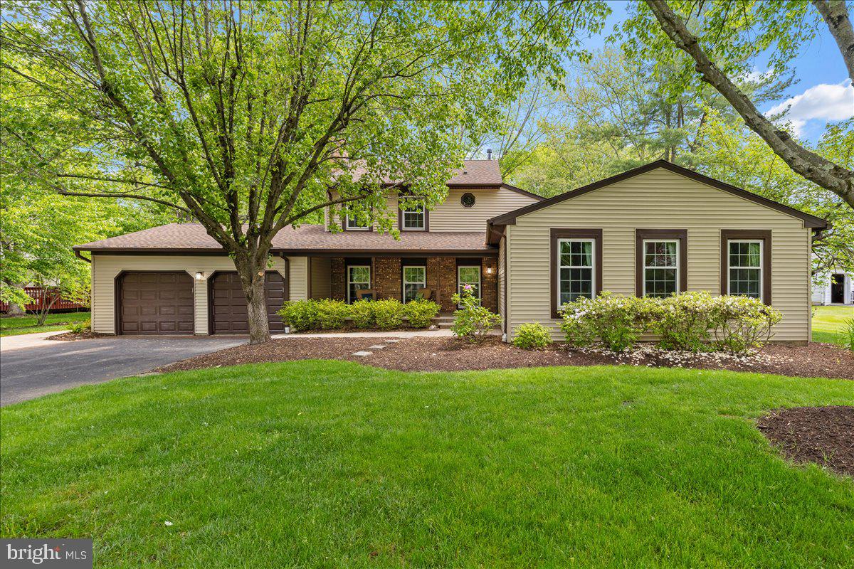a front view of a house with a yard and porch