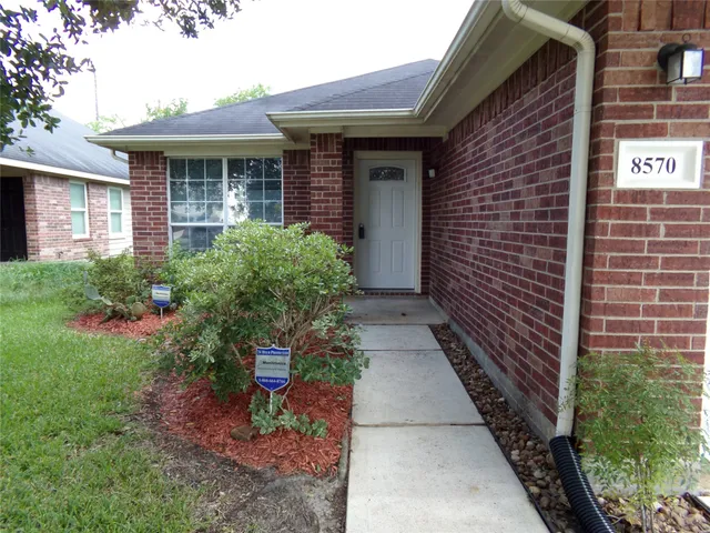a view of a pathway besides a house