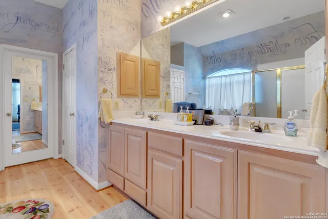 a bathroom with double sink and a mirror