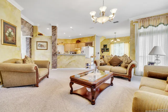 a living room with furniture a chandelier and a chandelier