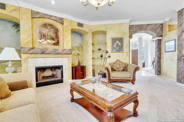 a living room with furniture and a fireplace