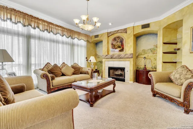 a living room with furniture fireplace and a large window