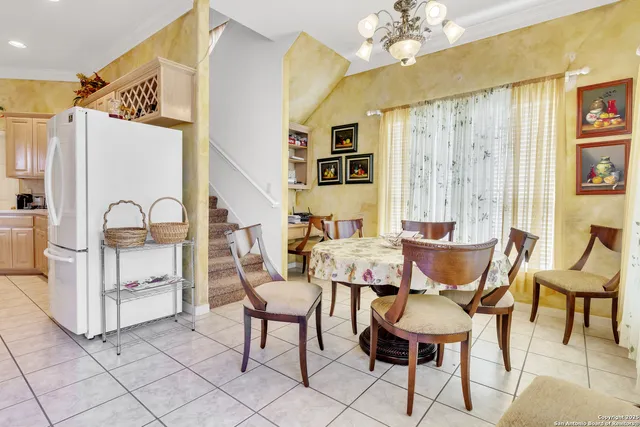 a view of a dining room with furniture and a chandelier
