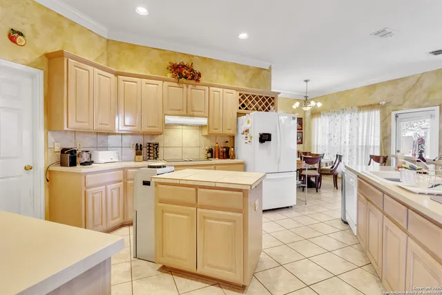 a kitchen with cabinets appliances and a counter top space