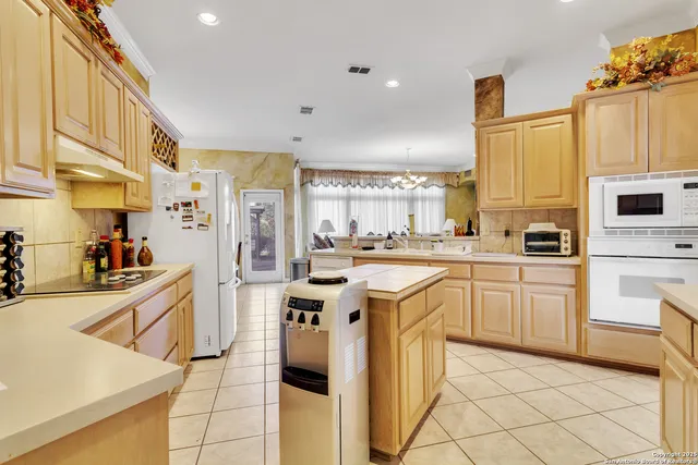 a kitchen with appliances cabinets and furniture