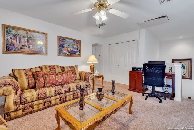 a living room with furniture a rug and a chandelier