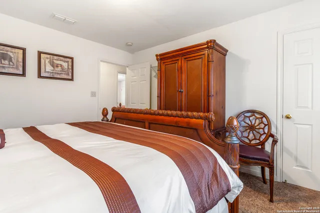 a bedroom with a bed and a dresser in it