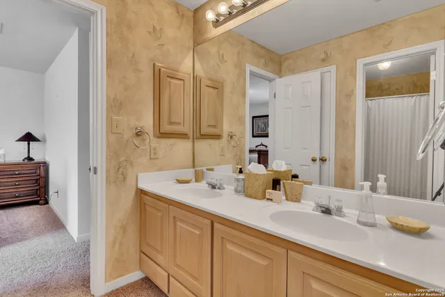 a bathroom with a sink double vanity and a mirror