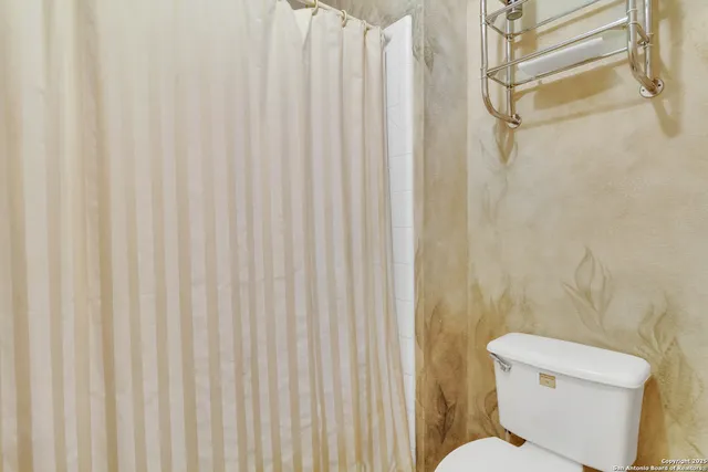 a bed room with a bed and a chair