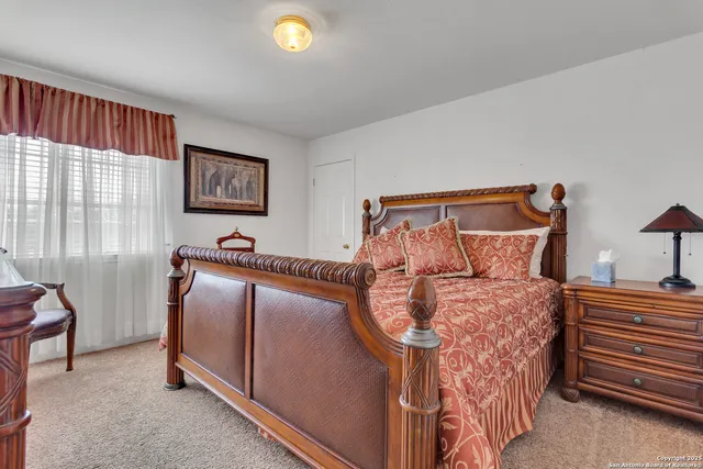 a bed sitting in a bedroom next to a window