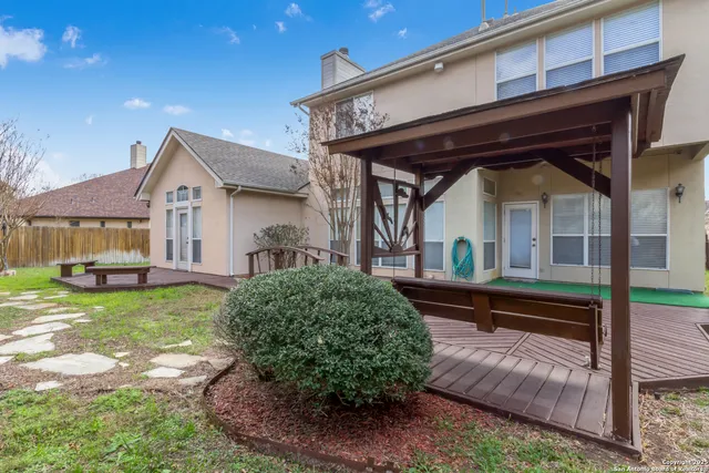 a view of a house with backyard and sitting area