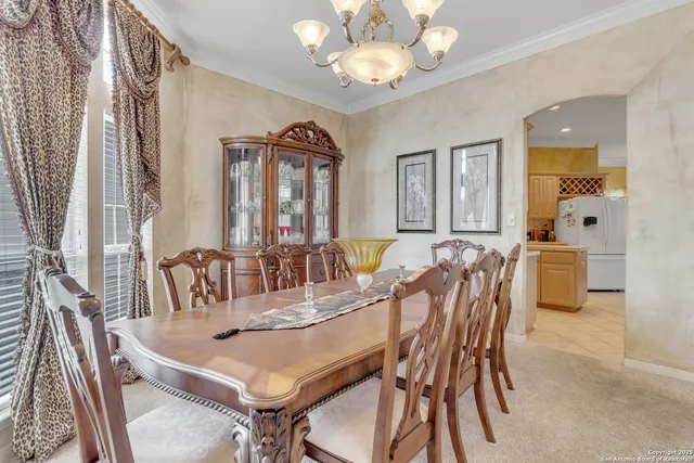 a view of a dining room with furniture and chandelier