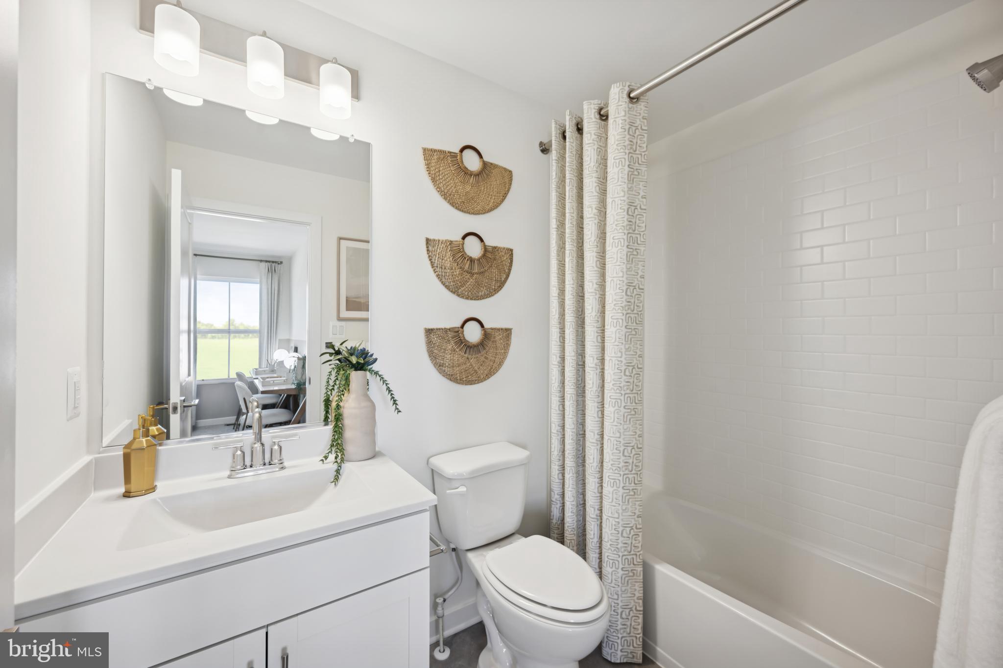 70 Thornton Avenue Ranson, WV 25438 - Photo 16 of 24 a bathroom with a toilet a sink and mirror