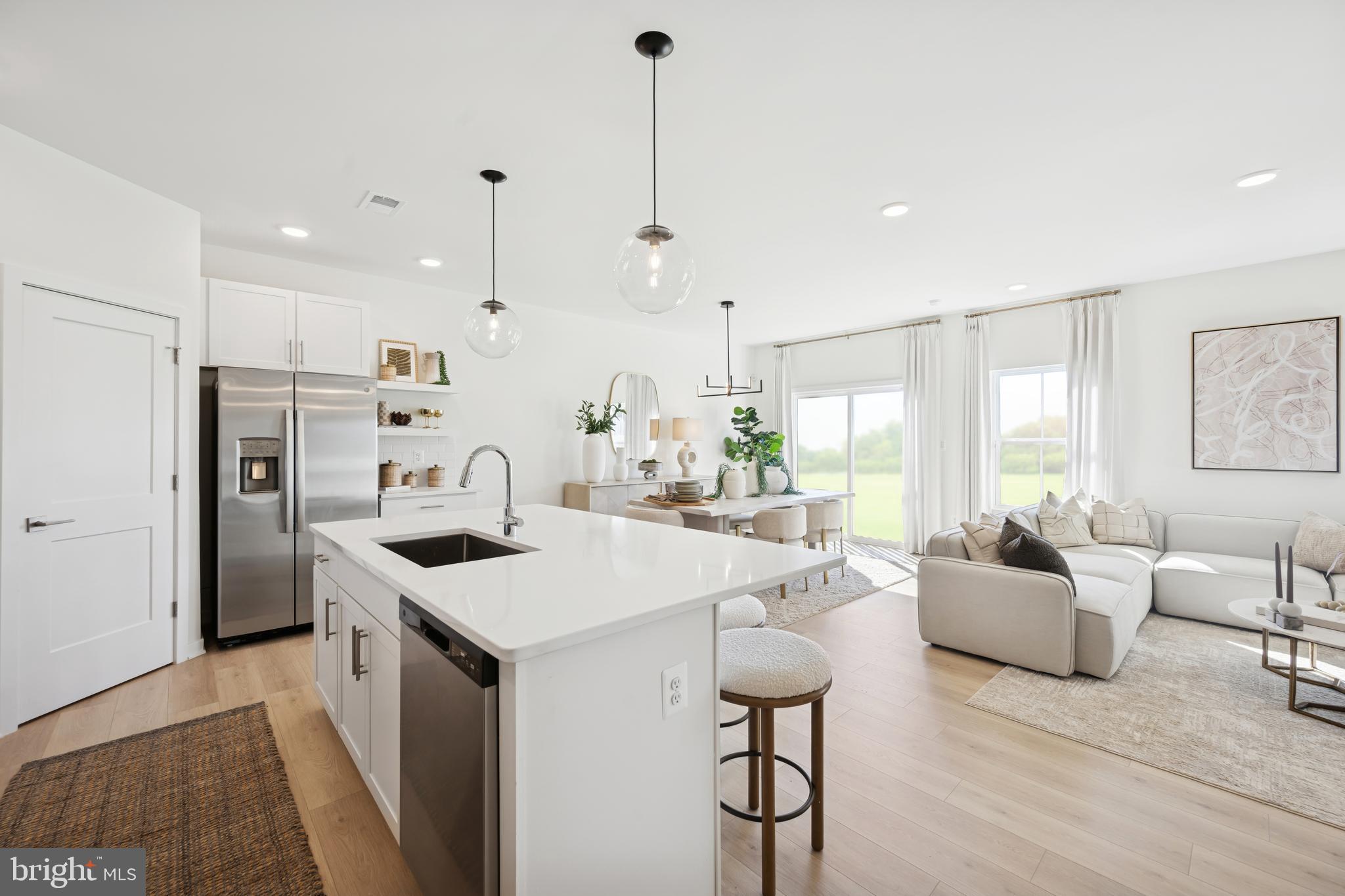 70 Thornton Avenue Ranson, WV 25438 - Photo 4 of 24 a open kitchen with stainless steel appliances kitchen island a white cabinets and couches