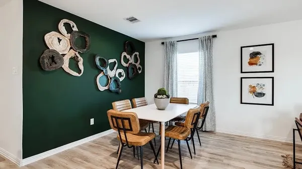 a dining room with a table and chairs