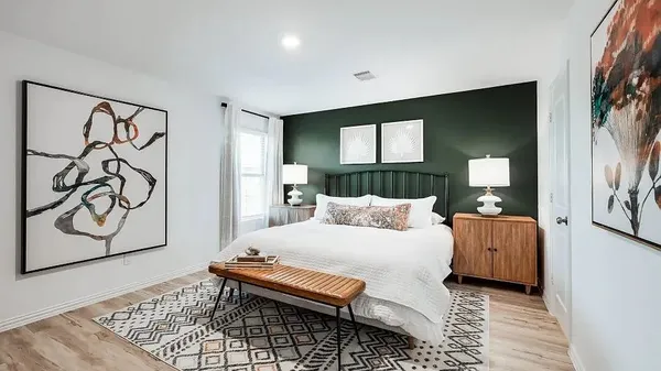 a bedroom with a bed and dresser