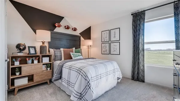 a spacious bedroom with a bed and a window