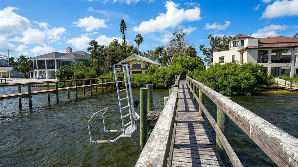 7401 Midnight Pass Road, Unit A Sarasota, FL 34242 - Photo 18 of 22 a view of a house with a wooden deck
