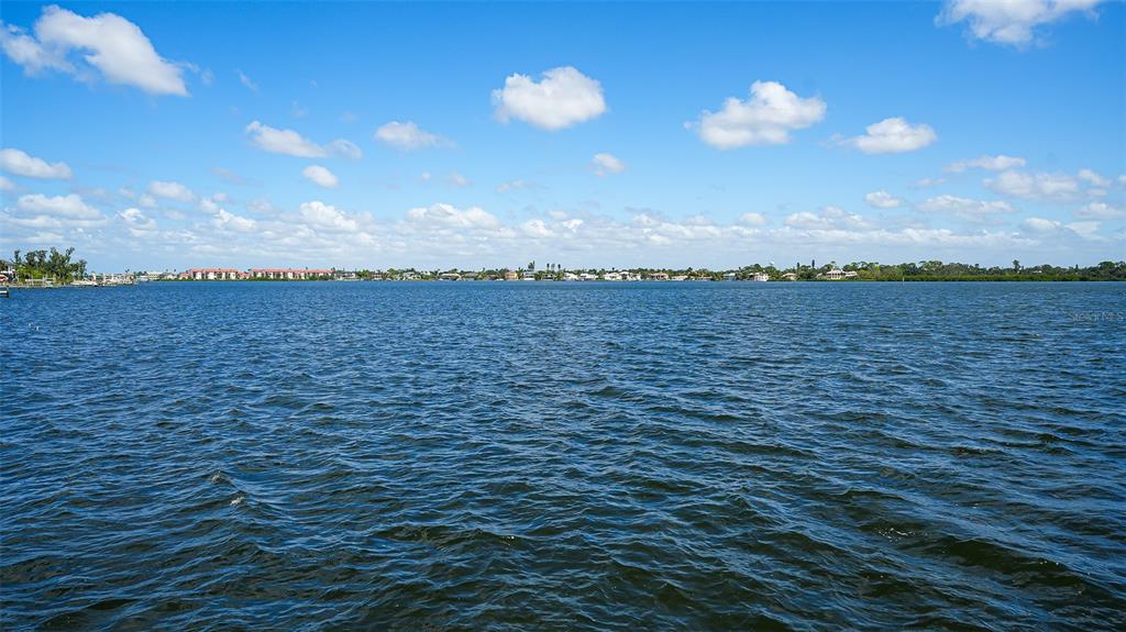 7401 Midnight Pass Road, Unit A Sarasota, FL 34242 - Photo 19 of 22 a view of a lake and sunset