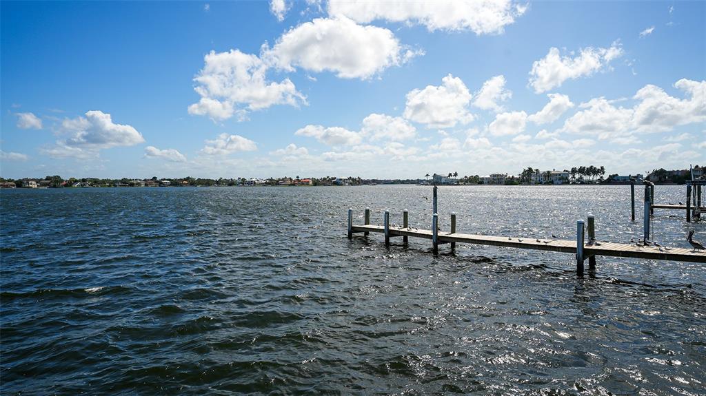 7401 Midnight Pass Road, Unit A Sarasota, FL 34242 - Photo 20 of 22 a view of a lake with outdoor seating