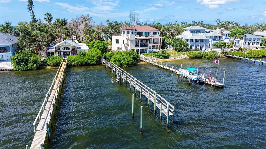 7401 Midnight Pass Road, Unit A Sarasota, FL 34242 - Photo 5 of 22 an aerial view of a house with a garden and lake view