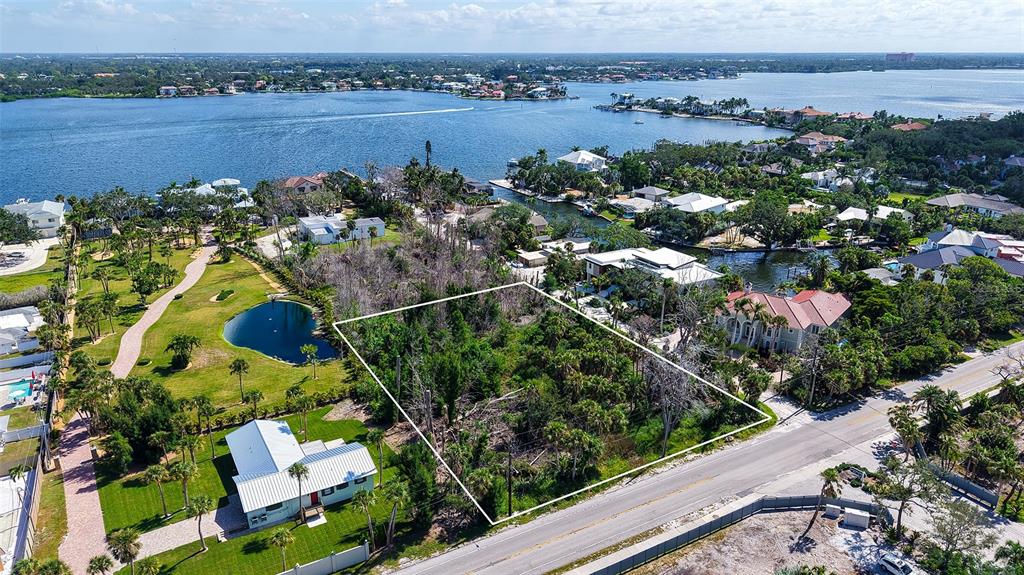 7401 Midnight Pass Road, Unit A Sarasota, FL 34242 - Photo 6 of 22 an aerial view of lake and residential houses with outdoor space