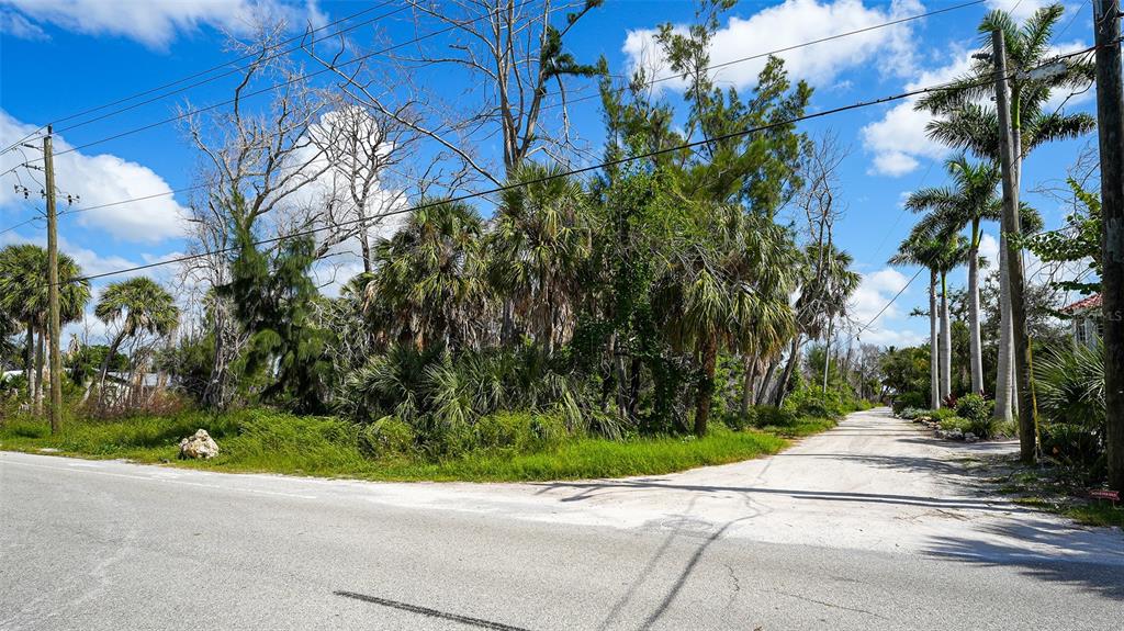 7401 Midnight Pass Road, Unit A Sarasota, FL 34242 - Photo 9 of 22 a view of a street with a small yard