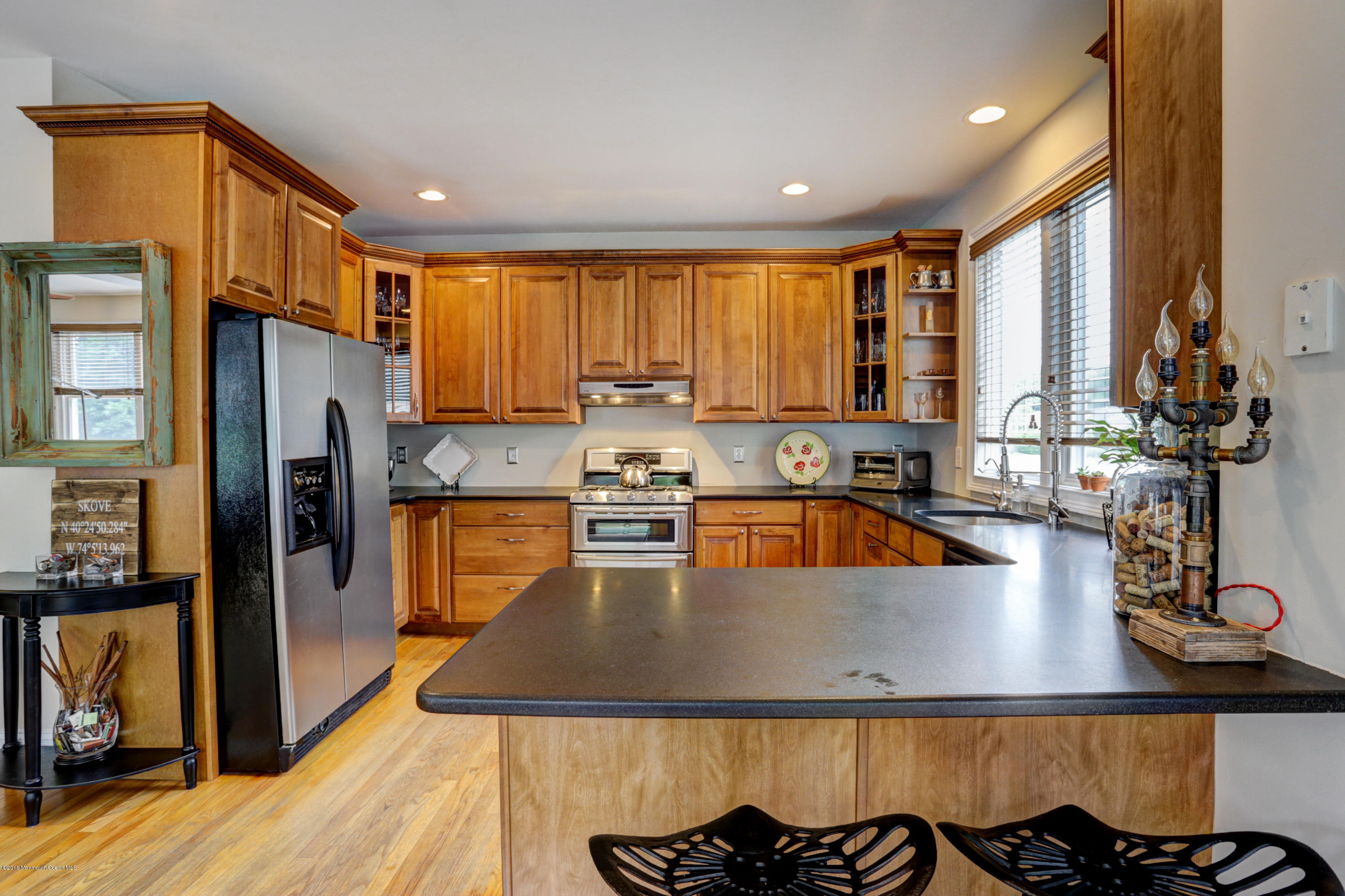 434 E Road Middletown, NJ 07718 - Photo 14 of 30 a kitchen with stainless steel appliances granite countertop a refrigerator a sink dishwasher a stove and white countertops with wooden floor