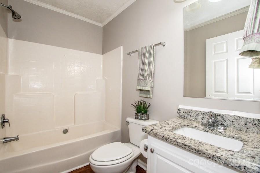 224 Stewart Rock Road Stony Point, NC 28678 - Photo 22 of 41 a bathroom with a granite countertop sink a toilet and shower