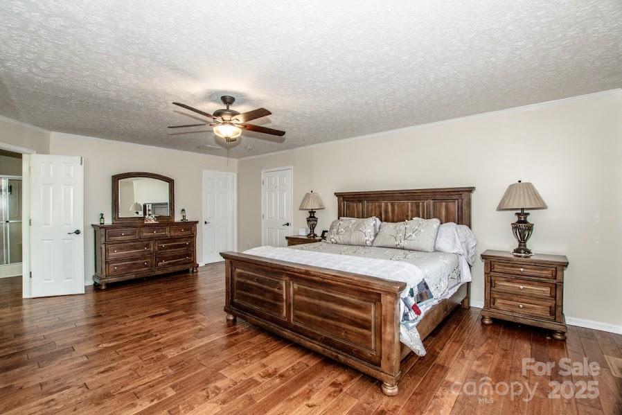 224 Stewart Rock Road Stony Point, NC 28678 - Photo 26 of 41 a bedroom with a bed and a dresser with wooden floor