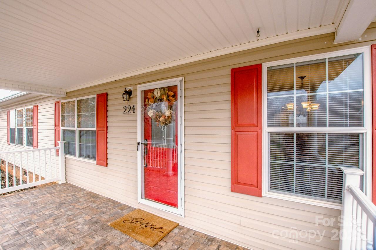 224 Stewart Rock Road Stony Point, NC 28678 - Photo 8 of 41 a view of a house with a door and balcony