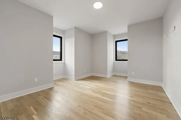 a view of a room with a sink and wooden floor