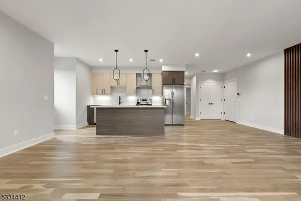 an empty room with wooden floor and a window