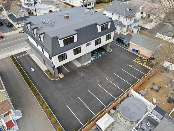an aerial view of residential houses with street