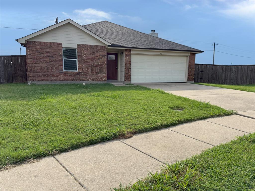 a front view of house with yard and garage